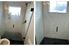 Thumbnail for Modern bathroom shower with glass enclosure and white tiles, showcasing cleanliness and style.
