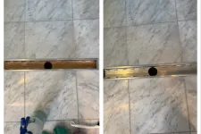 Thumbnail for Side-by-side images of a marble floor drain installed with a black circular drain cover and cleaning supplies nearby.