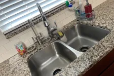Thumbnail for Double stainless steel kitchen sink with modern faucet on granite countertop under window with blinds