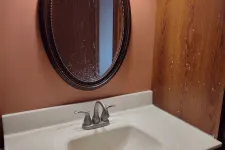 Thumbnail for a bathroom sink with a round mirror
