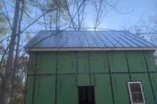 Thumbnail for a green building with a blue roof