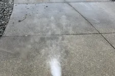 Thumbnail for a white sprinkler spraying water on a sidewalk