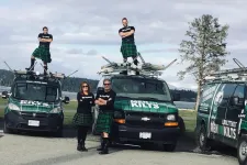 Thumbnail for a group of people standing next to a group of cars