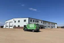 Thumbnail for a green truck parked in front of a building