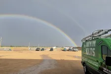 Thumbnail for a rainbow over a parking lot