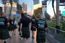 Thumbnail for Group of people wearing kilts and Men in Kilts window cleaning shirts walking on a sunny city sidewalk in Las Vegas.