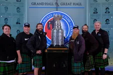 Thumbnail for Group of men in green plaid kilts posing around the Stanley Cup in the Hockey Hall of Fame Grand Hall.
