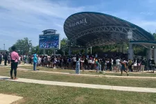 Thumbnail for Crowd gathers at Will Packer outdoor stage under clear sky during daytime event