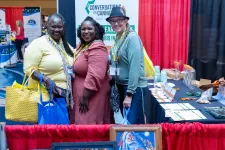 Thumbnail for a group of women standing next to a table with bags