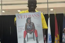 Thumbnail for Person holding a Women Veterans Magazine cover featuring a seated woman in red pants and patterned top.