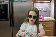 Thumbnail for a girl sitting at a table with a plate of food
