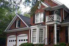 Thumbnail for a large brick house with a white picket fence and a white picket fence