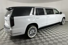 Thumbnail for White luxury stretched SUV limousine with black tinted windows on checkered showroom floor