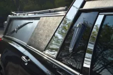 Thumbnail for Close-up of a luxury hearse, highlighting polished chrome, sleek design, and elegant finish.