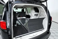 Thumbnail for Interior view of a spacious trunk in a black SUV with a sliding storage unit.