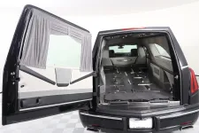 Thumbnail for Interior view of a luxury black vehicle showcasing a spacious cargo area with sleek design.