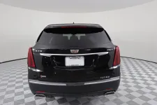 Thumbnail for Rear view of a black Cadillac XT5 Platinum showcasing sleek design and modern features.
