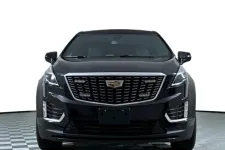 Thumbnail for Front view of a black Cadillac SUV with sleek design and distinctive grille.