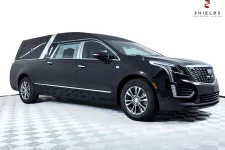 Thumbnail for Elegant black Cadillac hearse showcasing sleek design and premium features, ideal for professional services.