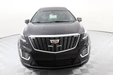 Thumbnail for Front view of a sleek black Cadillac XT5 showcasing modern design and luxury features.