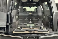 Thumbnail for Interior view of a spacious SUV trunk with foldable seats and modern features.