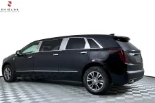 Thumbnail for Luxurious black Cadillac limousine with polished details, showcasing its elegant design side view.