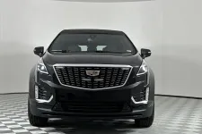 Thumbnail for Front view of a sleek black Cadillac SUV displaying modern design features.