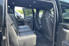 Thumbnail for Spacious rear seats of a black pickup truck with leather upholstery and open rear doors.