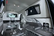 Thumbnail for Luxurious interior of a high-end vehicle with sleek black surfaces and elegant lighting details.
