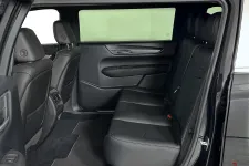 Thumbnail for Interior view of a luxury SUV showcasing spacious black leather back seats.