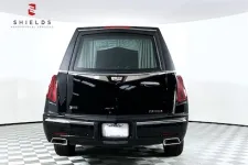 Thumbnail for Rear view of a black luxury hearse showcasing elegant design and features.