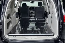 Thumbnail for Interior of a spacious van with a flat cargo area and folding seats, ideal for transporting goods.