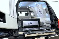 Thumbnail for Sleek, luxury hearse interior with elegant design and stylish lighting features.