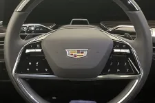 Thumbnail for Luxury Cadillac steering wheel with control buttons and emblem inside a modern vehicle interior.