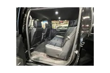 Thumbnail for Interior view of a spacious black SUV showcasing leather seats and modern design details.