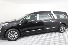 Thumbnail for A sleek black hearse with elegant design, showcasing modern luxury and funeral transport features.