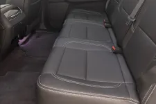 Thumbnail for Spacious backseat interior of a car with black leather seats and white stitching