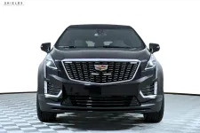 Thumbnail for Front view of a sleek black Cadillac XT5 with a modern design and shiny grille.