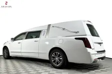 Thumbnail for Sleek white hearse with elegant design, showcasing professionalism and comfort for funeral services.