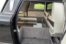 Thumbnail for Interior view of a sleek black hearse with elegant finishes and spacious storage.