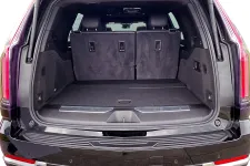 Thumbnail for Open trunk of a black SUV showing spacious cargo area and folded rear seats in a clean interior.