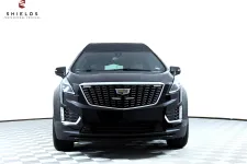 Thumbnail for Front view of a black Cadillac XT5 showcasing modern luxury design and prominent grille.
