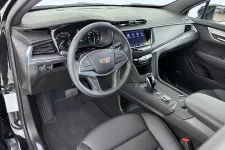 Thumbnail for Luxurious interior of a modern Cadillac showcasing leather seats and advanced technology dashboard.