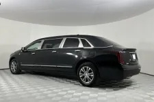Thumbnail for A sleek black luxury limousine parked in a clean, well-lit studio space.