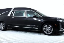 Thumbnail for A sleek black luxury hearse with elegant design features and smooth lines.