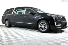 Thumbnail for Sleek black Cadillac hearse showcasing modern design and elegance against a plain background.