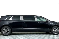 Thumbnail for A sleek black Cadillac SUV limousine displayed on a checkered floor backdrop.