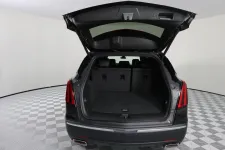 Thumbnail for Interior view of an SUV with the trunk open, showcasing ample cargo space and a sleek design.