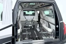 Thumbnail for Luxurious hearse interior with polished wood and sleek design, emphasizing elegance and sophistication.