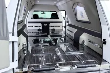 Thumbnail for Stylish, spacious interior of a modern hearse with polished surfaces and sleek design.
